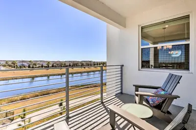 a balcony with two chairs and a table and a window at 6 Mi to Disney Resort Hideaway with Pool Access! in Kissimmee