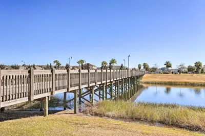 a wooden bridge over a body of water at 6 Mi to Disney Resort Hideaway with Pool Access! in Kissimmee