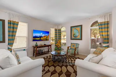 a living room with two white couches and a table at South Facing Pool with Spa and Lake View in Gated Resort of Bella Vida Nr Disney in Kissimmee