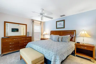 a bedroom with a bed and a dresser and a mirror at South Facing Pool with Spa and Lake View in Gated Resort of Bella Vida Nr Disney in Kissimmee