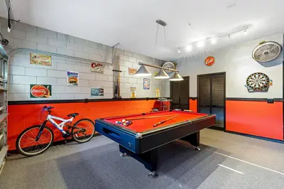 a room with a pool table and a bike in it at South Facing Pool with Spa and Lake View in Gated Resort of Bella Vida Nr Disney in Kissimmee