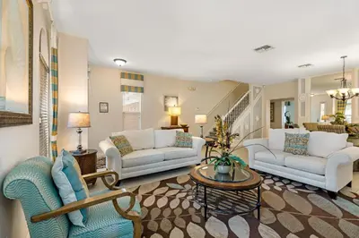 a living room with two couches and a table at South Facing Pool with Spa and Lake View in Gated Resort of Bella Vida Nr Disney in Kissimmee
