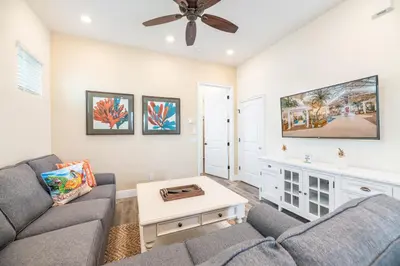 a living room with a couch and a ceiling fan at Mango Breeze Cottage With Private Pool Near Disney With Margaritaville Resort And Island H20 Waterpark Access - 2910Sr in Orlando