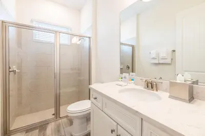 a bathroom with a shower and a toilet and a sink at Charming Cottage Near Disney With Margaritaville Resort & Island H20 Waterpark Access - 2918Sr in Orlando