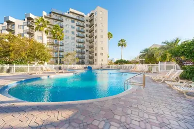a swimming pool in front of a apartment building at NEW - remodeled Studio close to Universal Studios in Orlando