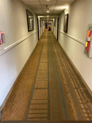 an empty hallway in a building with a long aisle at NEW - remodeled Studio close to Universal Studios in Orlando