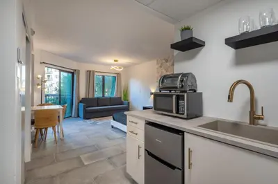 a kitchen with a sink and a microwave at NEW - remodeled Studio close to Universal Studios in Orlando