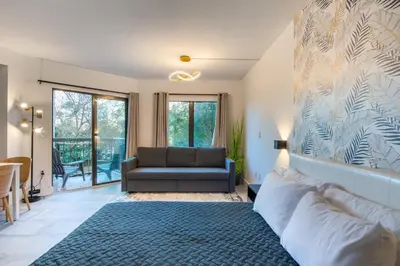 a living room with a couch and a chair at NEW - remodeled Studio close to Universal Studios in Orlando