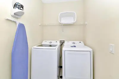 a bathroom with two washing machines in a room at Jamaican Spice Cottage Near Disney With Margaritaville Resort & Island H20 Waterpark Access - 2924Sr in Orlando