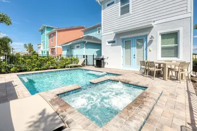 a swimming pool in a backyard with a table and chairs at Refreshing Blue Cottage Near Disney With Margaritaville Resort & Island H20 Waterpark Access - 2942Sr in Orlando