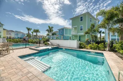a swimming pool in front of a house at Refreshing Blue Cottage Near Disney With Margaritaville Resort & Island H20 Waterpark Access - 2942Sr in Orlando