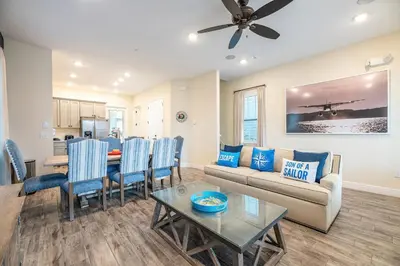 a living room with a couch and a table at Cozy Cottage Near Disney With Margaritaville Resort & Island H20 Waterpark Access - 3009La in Orlando
