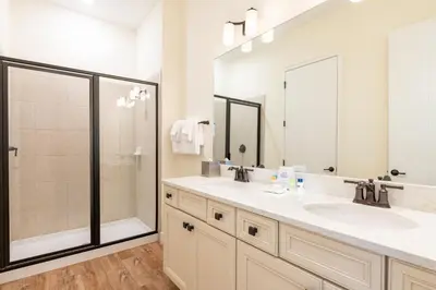 a bathroom with two sinks and a shower at Charming Cottage With Private Hot Tub Near Disney With Margaritaville Resort & Island H2O Access - 3025Sp in Orlando