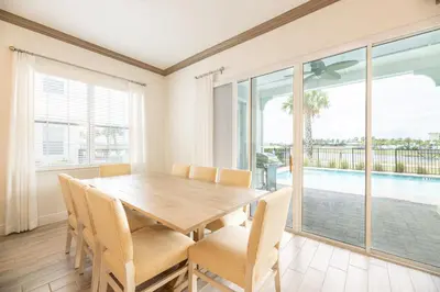a dining room with a wooden table and chairs at Brilliant Cottage Near Disney With Private Pool & Margaritaville Resort & Island H20 Waterpark Access - 3080Ph in Orlando