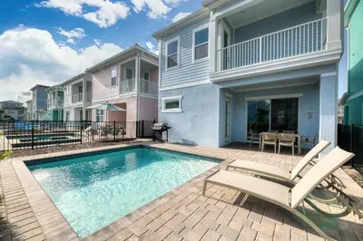 a swimming pool in front of a house at The Mermosa Cottage With Private Pool Near Disney With Margaritaville Resort & Island H2O Access - 8016St in Orlando