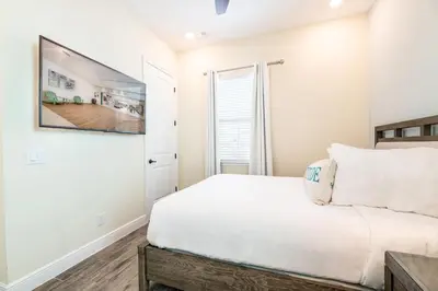 a white bedroom with a bed and a window at The Mermosa Cottage With Private Pool Near Disney With Margaritaville Resort & Island H2O Access - 8016St in Orlando
