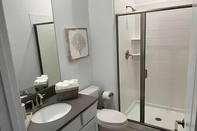 a bathroom with a toilet and a sink and a shower at Storey Lake home close to Disney and other parks in Kissimmee