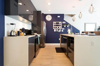 a kitchen with blue walls and white counter tops at Gorgeous and New House at Le Reve Resort (214221) in Kissimmee