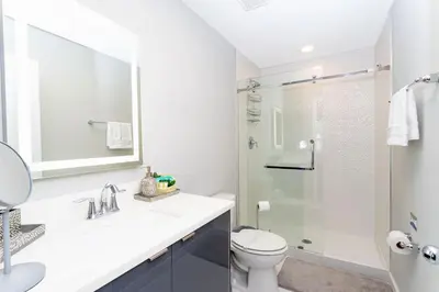 a white bathroom with a toilet and a shower at Gorgeous and New House at Le Reve Resort (214221) in Kissimmee