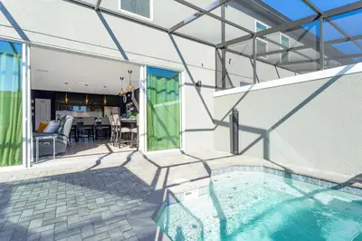 a house with a swimming pool and a patio at Gorgeous and New House at Le Reve Resort (214221) in Kissimmee