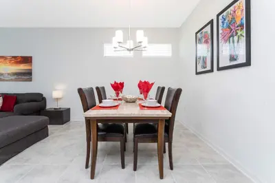 a dining room with a table and chairs at Gorgeous 3Bd 8 Guests @Storey Lake Resort Close to Disney 101 3191 in Kissimmee