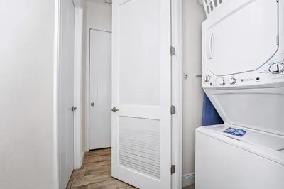 a laundry room with a washer and dryer at Beautiful Cottage Near Disney With Margaritaville Resort & Island H2O Access - 3029La in Orlando