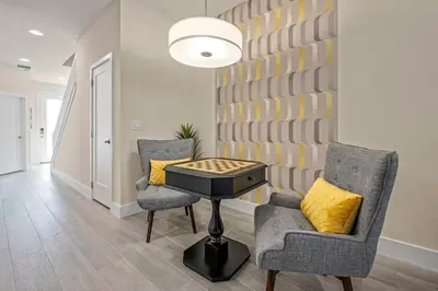 a living room with two chairs and a table at Hidden Forest 3 Bedroom Vacation Home 2020 in Clermont