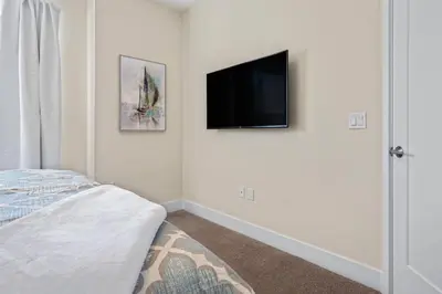 a bedroom with a bed and a flat screen tv on the wall at Hidden Forest 3 Bedroom Vacation Home 2020 in Clermont