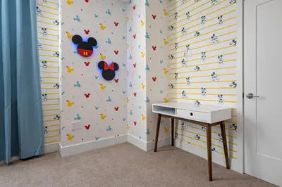 a bathroom with a sink and mickey mouse wallpaper at Hidden Forest 3 Bedroom Vacation Home 2020 in Clermont