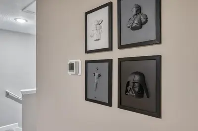 a group of framed pictures hanging on a wall at Formosa Valley by UNE Homes in Orlando