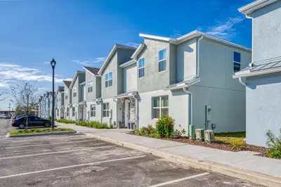 a row of apartment buildings with a parking lot at Formosa Valley by UNE Homes in Orlando