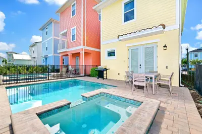 a pool with a table and chairs next to a house at Inviting Cottage With Private Pool Near Disney With Margaritaville Resort & Island H2O Access - 8022Kd in Orlando