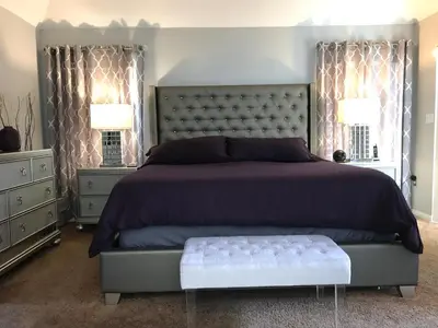 a bedroom with a large bed and two windows at Sunny South Facing Pool with Hot Tub and Lake View Near Disney in Kissimmee