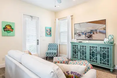 a living room with a couch and a mirror at Chat Eau Champagne Cottage With Private Pool Near Disney With Margaritaville Resort & Island H2O Access - 8030Kd in Orlando