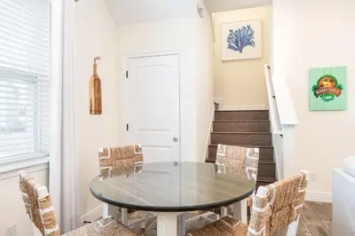 a dining room with a glass table and chairs at Chat Eau Champagne Cottage With Private Pool Near Disney With Margaritaville Resort & Island H2O Access - 8030Kd in Orlando