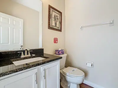 a bathroom with a sink and a toilet at Family retreat w pool, spa & BBQ grill in Orlando