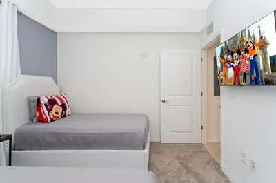 a small bedroom with a bed and a tv at Stunning 2 Bedroom Apartment Close to Disney 304 3191 in Kissimmee