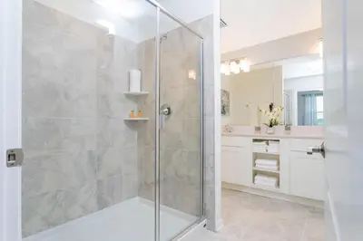 a shower with a glass door in a bathroom at Stunning 2 Bedroom Apartment Close to Disney 304 3191 in Kissimmee