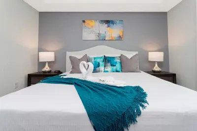 a bedroom with a white bed with a blue blanket at Gorgeous 2 Bedroom Apartment Close to Disney 305 31911 in Kissimmee
