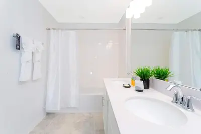 a white bathroom with a sink and a mirror at Gorgeous 2 Bedroom Apartment Close to Disney 305 31911 in Kissimmee