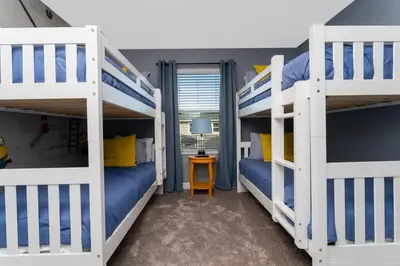 a bedroom with two bunk beds and a table at Gorgeous 4 Bd w/ Pool Close to Disney @ Storey Lake 2963 in Kissimmee