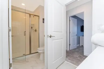 a bathroom with a toilet and a shower at Gorgeous 4 Bd w/ Pool Close to Disney @ Storey Lake 2963 in Kissimmee