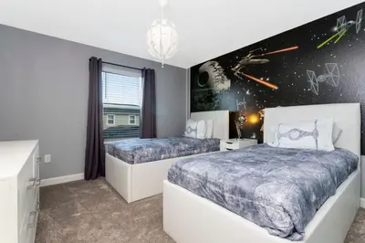 two beds in a bedroom with a star wars wall at Gorgeous 4 Bd w/ Pool Close to Disney @ Storey Lake 2963 in Kissimmee