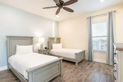 a bedroom with two beds and a ceiling fan at Vibrant Cottage With Private Pool Near Disney With Margaritaville Resort & Island H2O Access - 8031Kd in Orlando