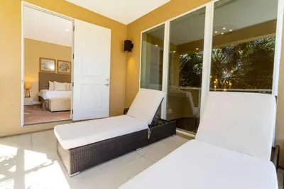 a room with two chairs and a bed and a mirror at Stunning 4 Bd Close To Disney @ Magic Village 3247 in Orlando