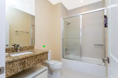 a bathroom with a shower and a toilet and a sink at Stunning 4 Bd Close To Disney @ Magic Village 3247 in Orlando