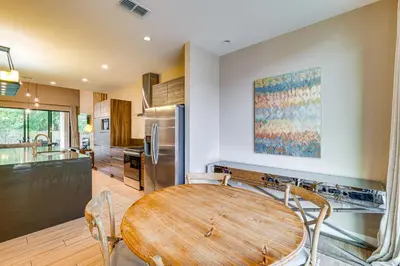 a kitchen with a wooden table and chairs at Magic Villas Townhome about 5 Mi to Disney Parks! in Orlando