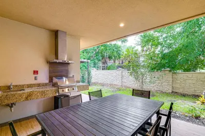 an outdoor kitchen with a table and a stove at Magic Villas Townhome about 5 Mi to Disney Parks! in Orlando
