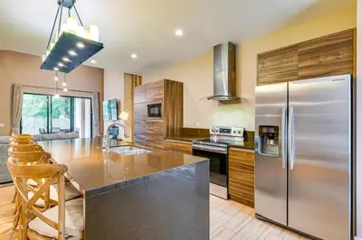 a kitchen with a large stainless steel refrigerator at Magic Villas Townhome about 5 Mi to Disney Parks! in Orlando