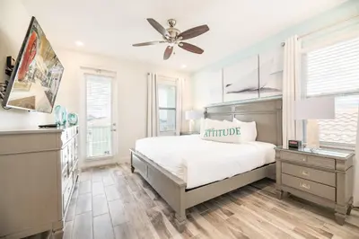 a bedroom with a bed and a ceiling fan at Seaweed Paradise Cottage Near Disney With Margaritaville Resort & Island H2O Access - 8057Kd in Orlando